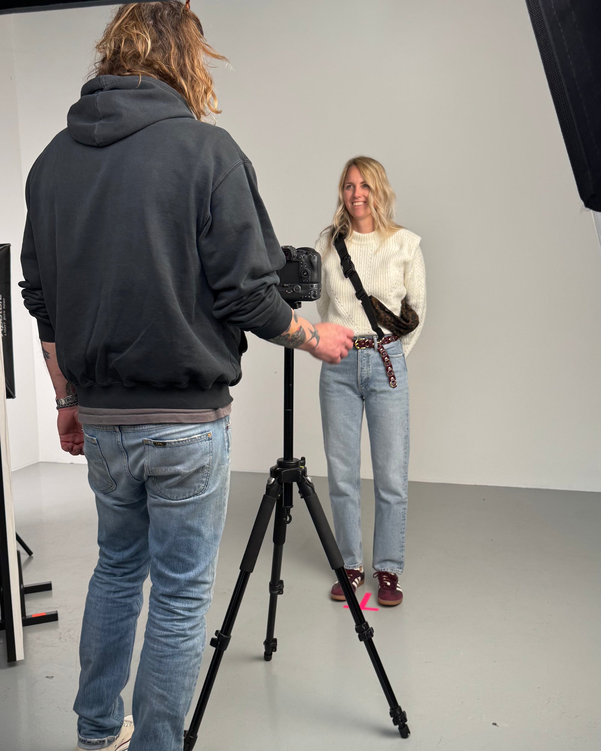 Behind-the-scenes of a Wildride toddler carrier photoshoot, featuring a parent carrying a child in a hip carrier. The outdoor setting captures the spirit of adventure, comfort, and connection that defines the best baby carrier experience.